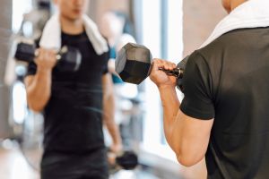 Man curling dumbbells